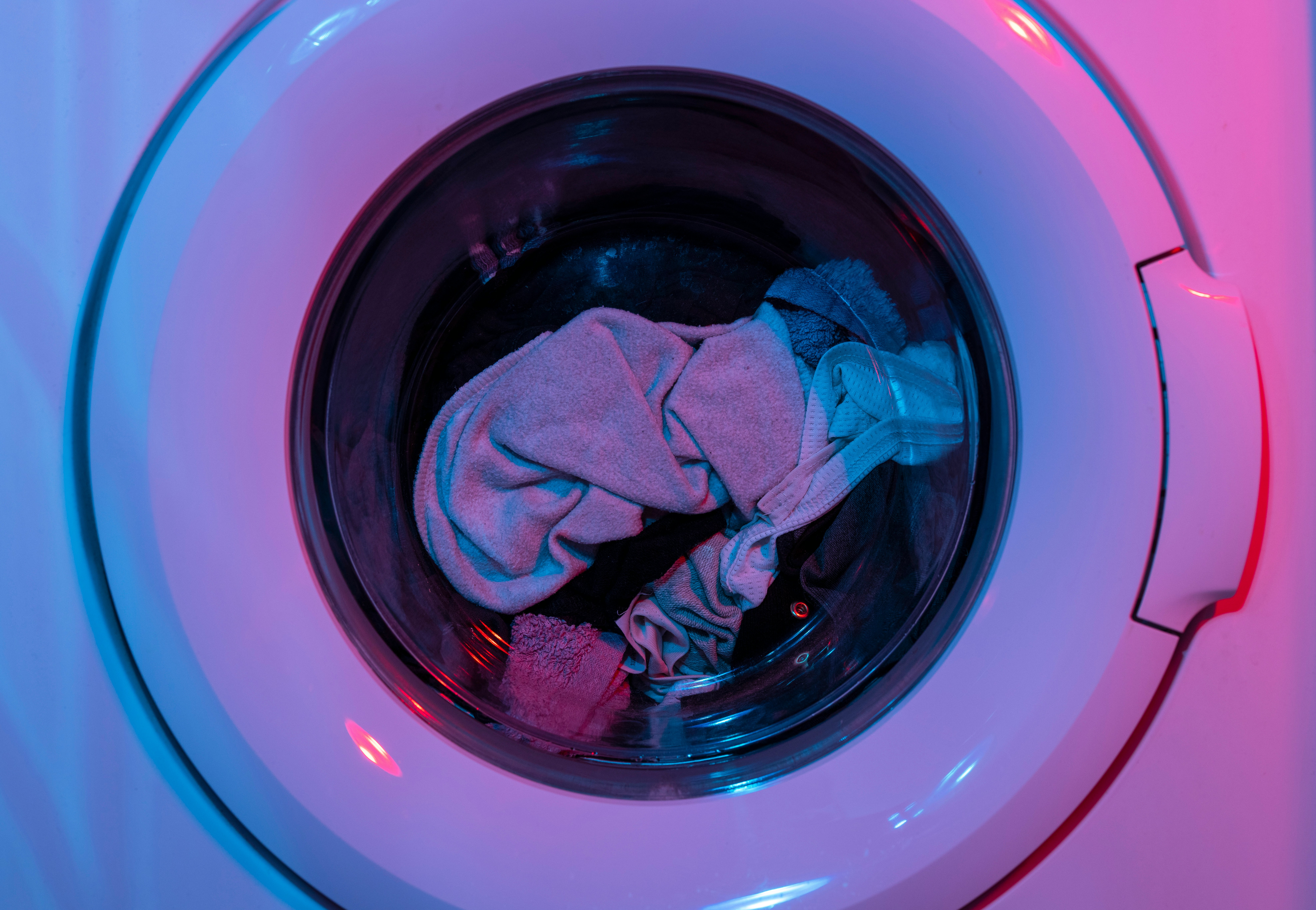 Front load washer drum showing laundry inside — ApplianceEdge buying guide